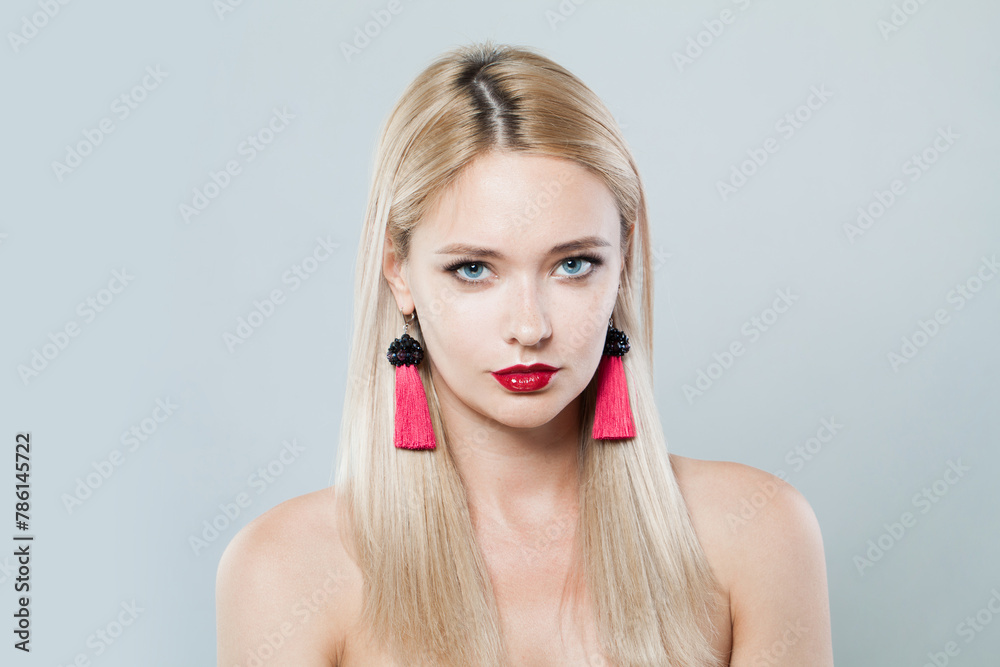 Gorgeous fashion female model with long blonde hairstyle and shiny fresh skin on white background, studio portrait Gorgeous fashion female model with long blonde hairstyle and shiny fresh skin on white background, studio portrait