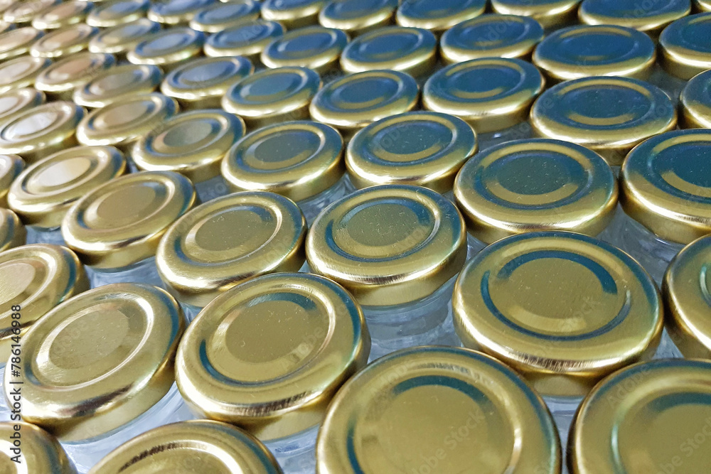 Golden lids and glass jar background Golden lids and glass jar background