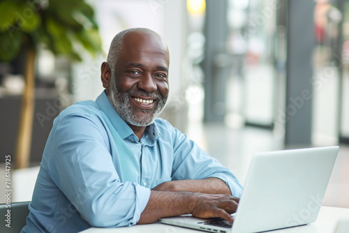 Senior man with laptop enjoying work