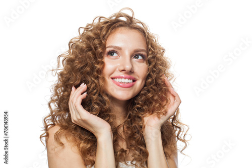 Positive fashion model with frizzy hair, natural makeup and healthy clean skin posing on white background. Skincare, haircare and cosmetology concept