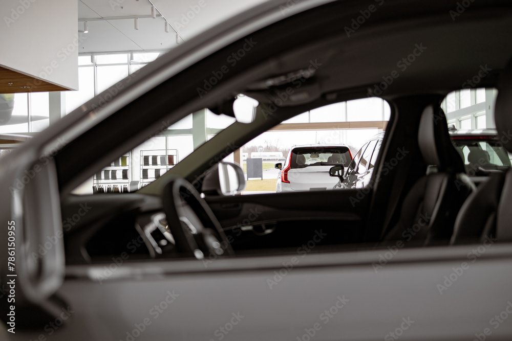 Cars dealership parking lot. Image of new vehicles in car showroom. Cars for sale, copy space. Automotive Industry.