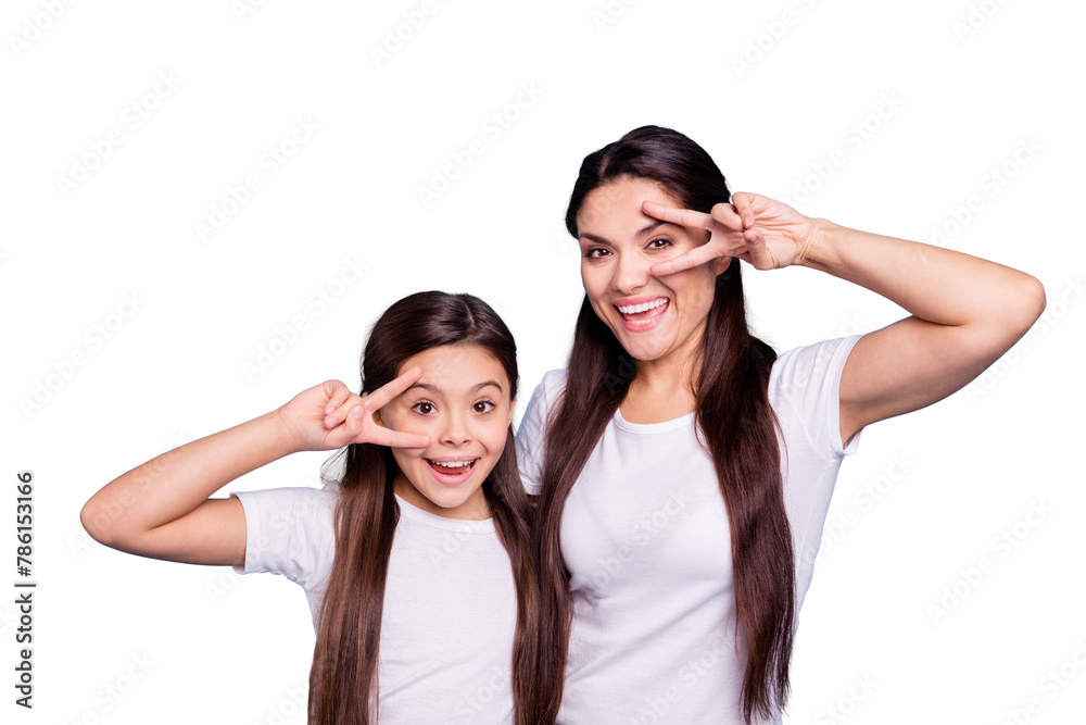 Close up photo cheer two people brown haired mum small little daughter hands arms fingers show v-sign say hi yell delighted amazed wear white t-shirts isolated bright blue background Close up photo cheer two people brown haired mum small little daughter hands arms fingers show v-sign say hi yell delighted amazed wear white t-shirts isolated bright blue background