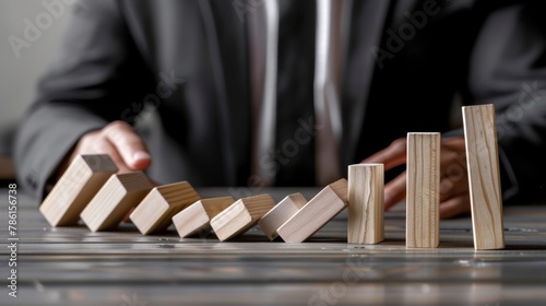 A man stands in the way of dominoes falling. Conflict management metaphor.