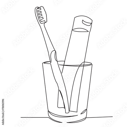 toothpaste and brush in a glass