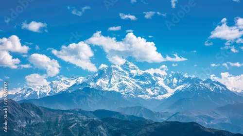 Majestic mountain landscape with snow peaks under blue sky © Sasint