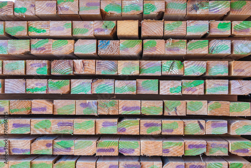 Stack of colorful wooden planks construction in the warehouse in industry. Stacks with pine lumber  wood harvesting shop  Stacked wooden boards for construction. 