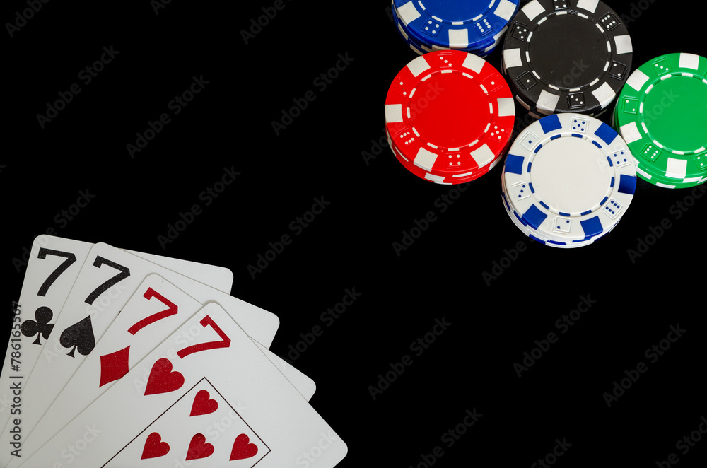 Obraz premium Poker chips and cards in a casino on a black background