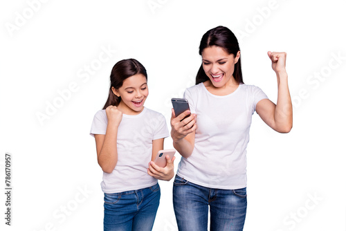 Close up photo beautiful two people brown haired mom small little daughter hold telephone reader great news fists in air win free sale discount wear white t-shirts isolated bright blue background © deagreez