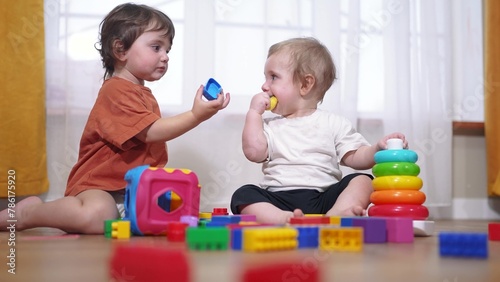 baby toddler group playing with toys. happy family a kid dream concept. baby toddler playing on the floor indoors with toys in kindergarten lifestyle. children group playing toys