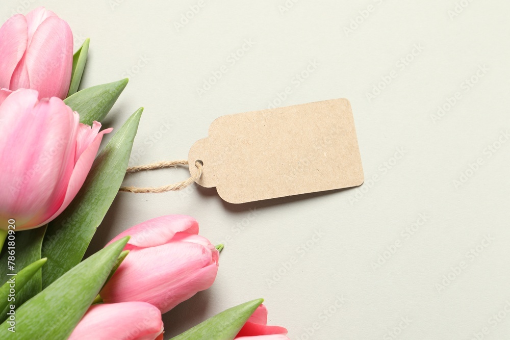 Fototapeta premium Happy Mother's Day. Beautiful flowers with blank card on light background, flat lay