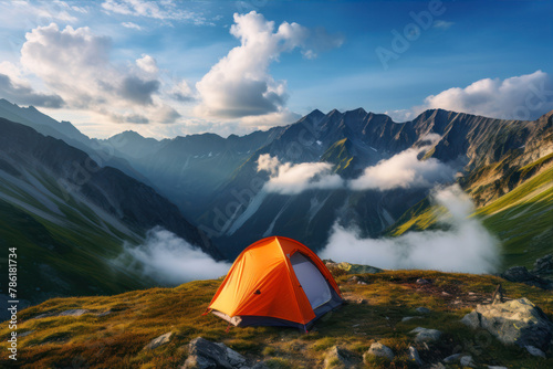 Camping in the mountains on a background of blue sky with clouds