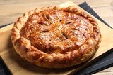Tasty homemade pie with filling on wooden table