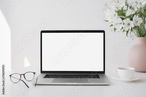 Laptop computer with empty blank mockup screen over white modern living room design. Home office, workplace, working or studying from home, distance learning, business concept