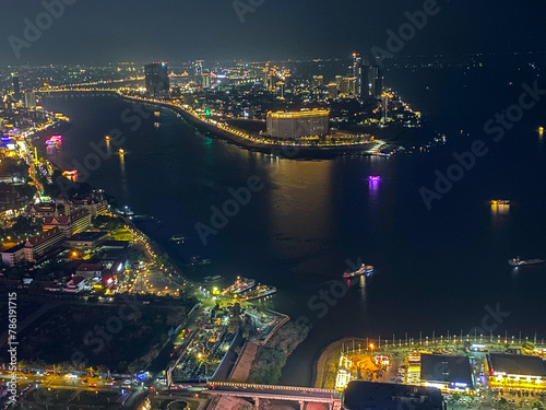 Cityscape of scenic Phnom Penh at night with the Mekong and Tonle Sap rivers and boats in Cambodia