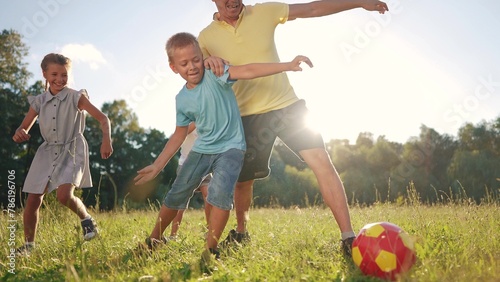 happy family playing ball in the park. a group of children playing ball at sunset in nature. happy family kid dream concept. children playing soccer in the park in nature lifestyle