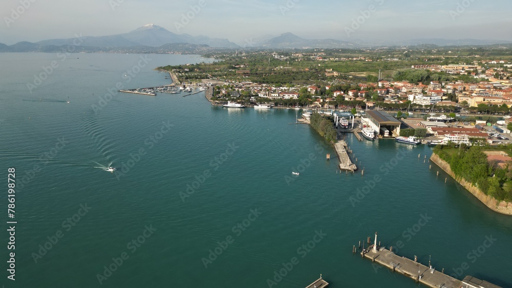 Beautiful panoramic aerial view of Lake Garda. High top view of water landscape with hills of mountains. Peschiera del Garda, Italia. Copy space