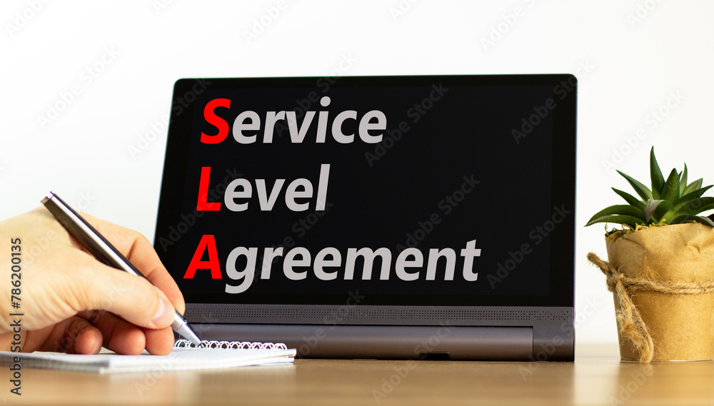 SLA service level agreement symbol. Concept words SLA service level agreement on beautiful black tablet. Beautiful white background. Business SLA service level agreement concept. Copy space. SLA service level agreement symbol. Concept words SLA service level agreement on beautiful black tablet. Beautiful white background. Business SLA service level agreement concept. Copy space.