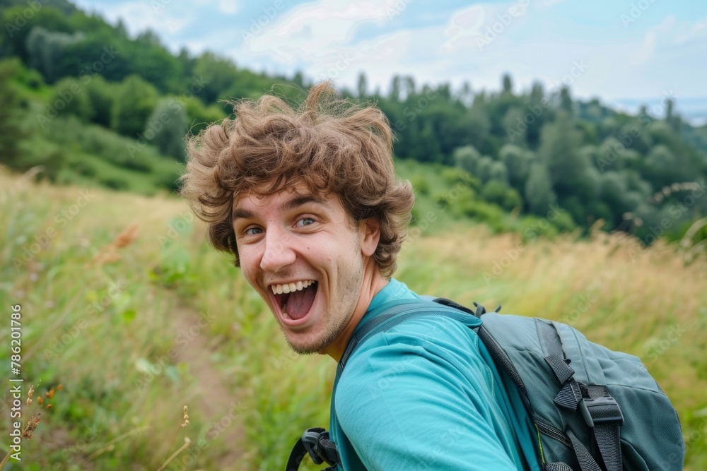 Selfie of a happy young man excited while hiking in the nature