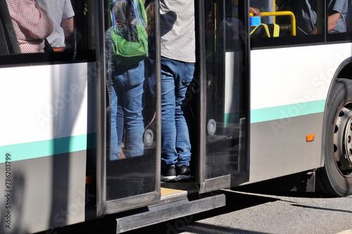 Bus with open doors and full of passengers, public transport