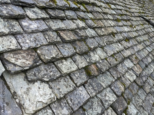 Old broken stone roof tiles, slate grey