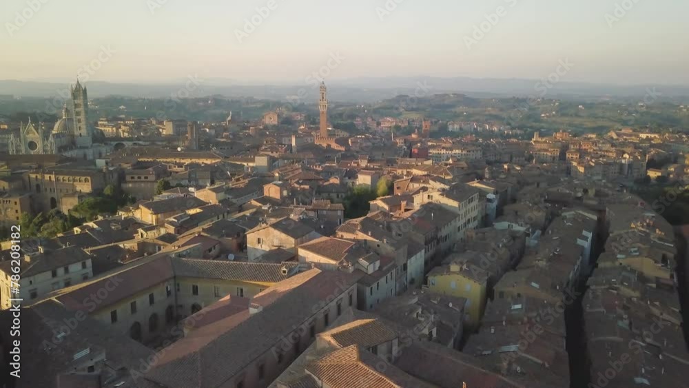 Aerial sunset cityscape of Siena drone fly above old medieval town in Tuscany Italy 