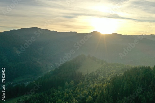 Aerial view of beautiful mountain landscape with green trees at sunrise © New Africa