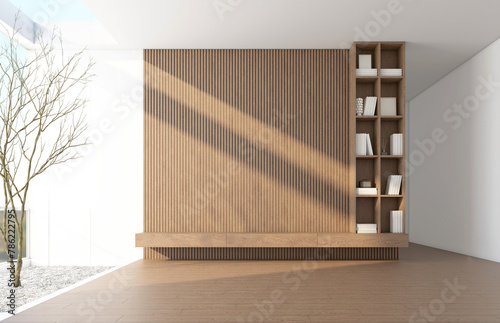 Morning light and trees outside the bare glass wall. Inside there is a Modern Japanese-style living room with a TV cabinet and built-in bookshelf and the doorway. 3d rendering.