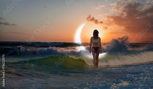 A beautiful woman swimming in the sea at dusk Crescent moon in the background