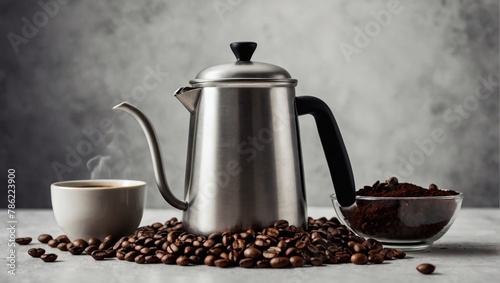 Coffee pot with mugs, bowl of roasted coffee beans and coffee grounds on white grunge background.