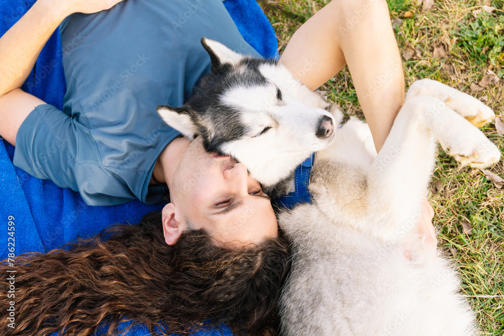 Horizontal photo shared affection between a man and his husky outdoors. Lifestyle concept. Horizontal photo shared affection between a man and his husky outdoors. Lifestyle concept.