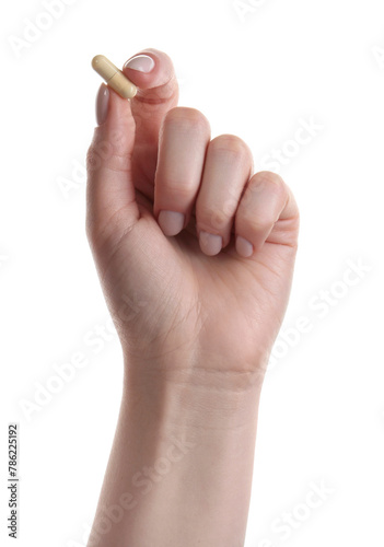 Woman holding vitamin capsule on white background, closeup. Health supplement