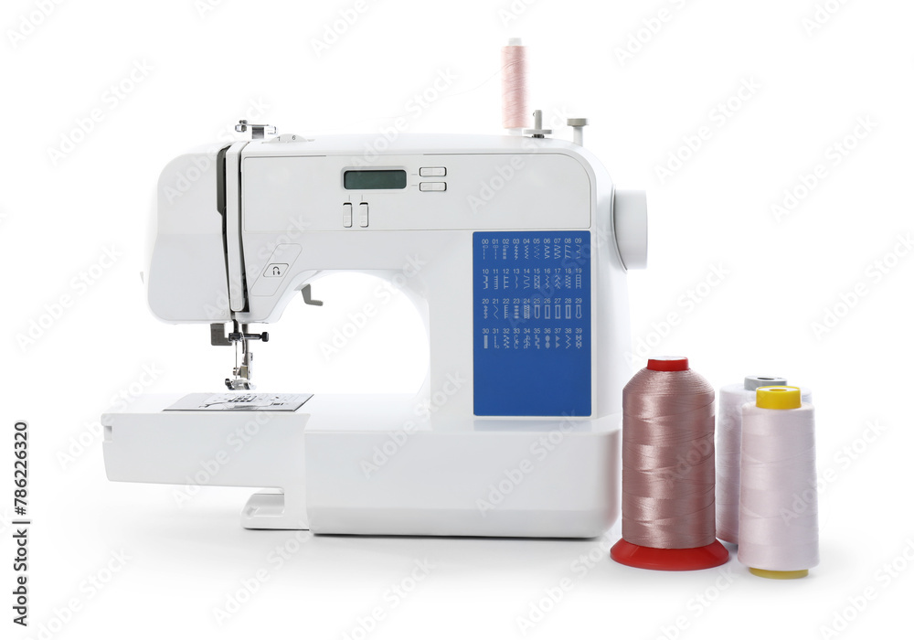 Sewing machine and spools of threads isolated on white
