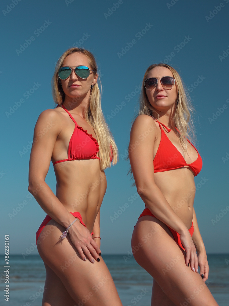 young women in red swimsuit on the beach young women in red swimsuit on the beach