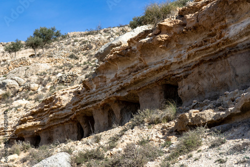 Natural walk next to the júcar river, popular cave houses, carved into the mountain,  region of La Manchuela, in Alcalá del Júcar (Albacete, Spain). photo