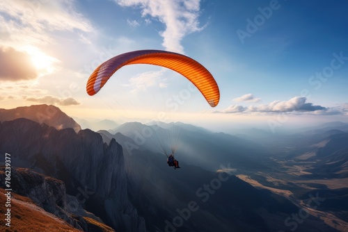 paraglider flies over the mountains, beautiful light