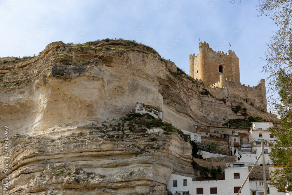 Panoramic view of the town of Alcalá del Júcar. Its popular cave houses, carved into the mountain, the castle and Church of San Andrés in the gorge of the júcar rive, Albacete, Spain.
