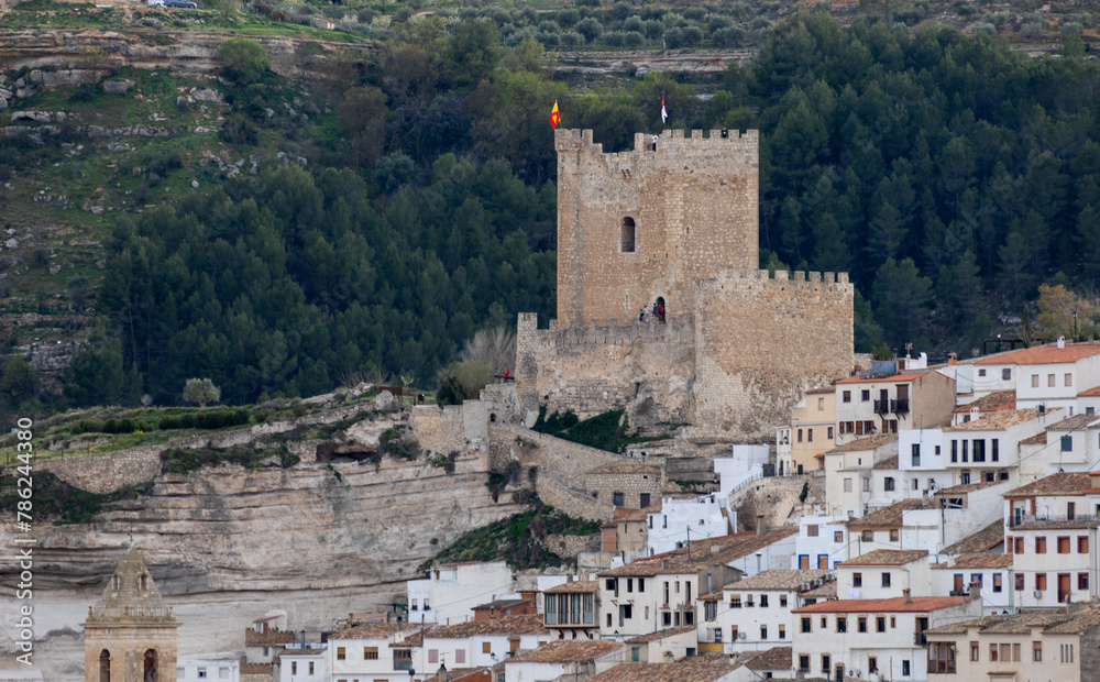 Panoramic view of the town of Alcalá del jucar from Las Eras viewpoint. Its popular cave houses, carved into the mountain, the castle and Church of San Andrés in the gorge of the jucar river, Albacete