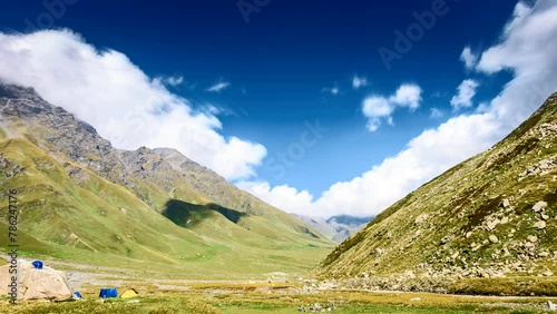 Beautiful timelapse of Himalayan mountain valley during Pin Bhaba pass trek in India. camping tent in foreground photo