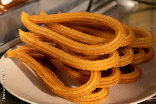 Detalle de churros en un plato blanco photo