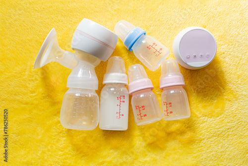 Breast pumps and bottles,Breast pump and feeding bottle for newborn baby with blanket background  photo