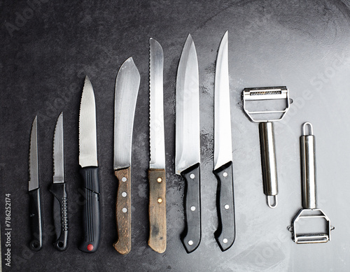 Knives, tools and kitchen equipment on table for professional chef, restaurant and culinary steel. Instrument, cutlery and blade for gourmet cafe, cutting and catering service in studio for meal prep