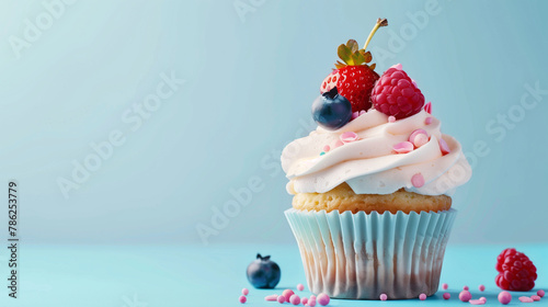 cupcake on blue background with copy space