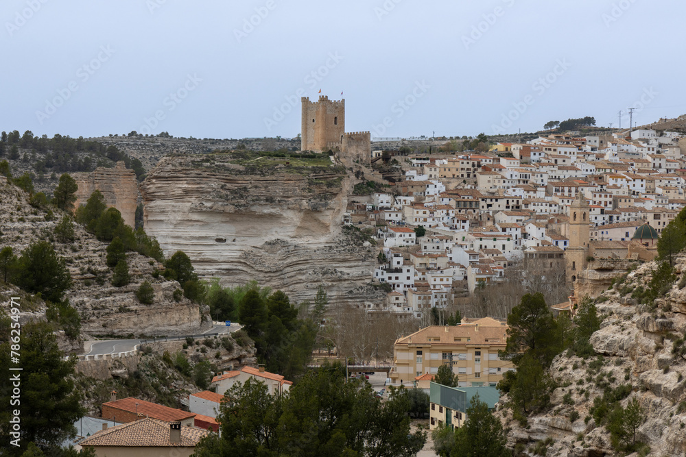 Panoramic view of the town of Alcalá del Júcar. Its popular cave houses, carved into the mountain, the castle and Church of San Andrés in the gorge of the júcar river, Albacete, Spain.