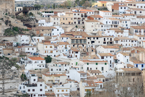 Panoramic view of the town of Alcalá del Júcar. Its popular cave houses, carved into the mountain, the castle and Church of San Andrés in the gorge of the júcar river, Albacete, Spain. © MARIA ALBI
