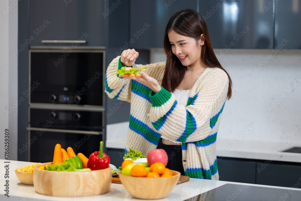 Diet lose weight and foods concept - Asian young attractive woman making sandwich clean vegetables healthy food for breakfast in morning at home. healthy food for health Diet lose weight and foods concept - Asian young attractive woman making sandwich clean vegetables healthy food for breakfast in morning at home. healthy food for health