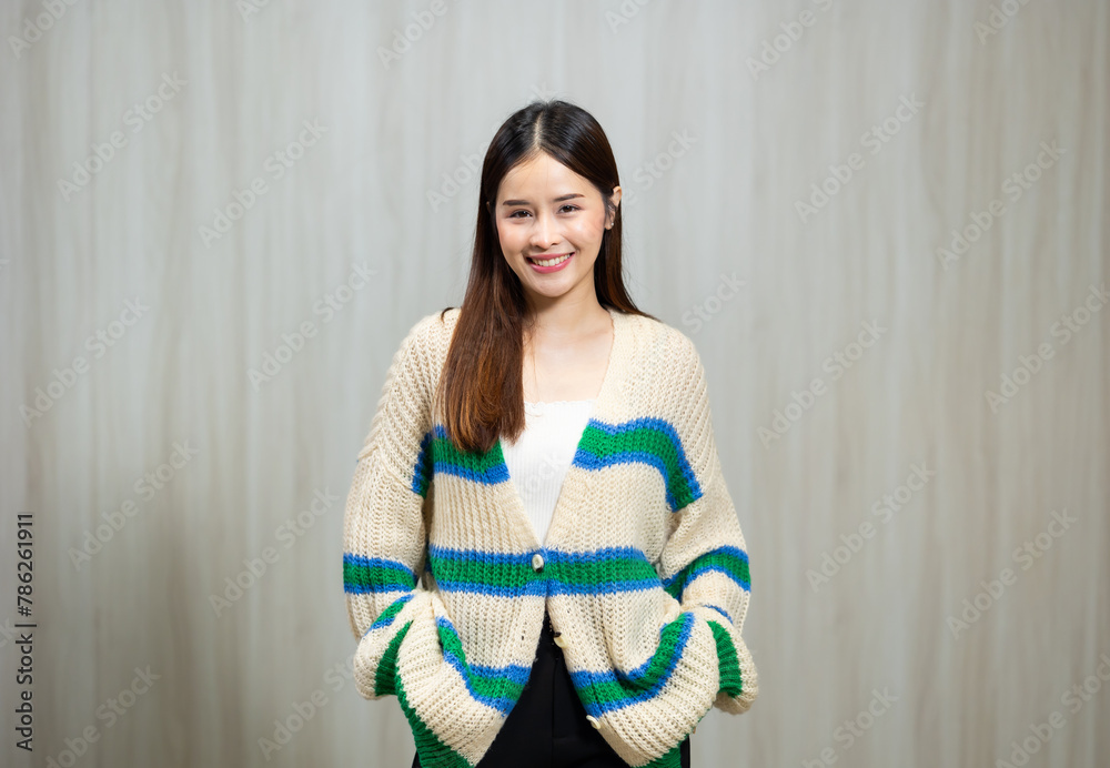 Portrait People lifestyle concept - Asian young woman in white and green winter knitted sweater shirt standing wood wall background Portrait People lifestyle concept - Asian young woman in white and green winter knitted sweater shirt standing wood wall background