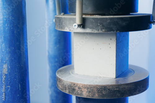 Control quality of sample concrete cube in machine press, compressive strength test. Concept laboratory of industrial building materials © Parilov