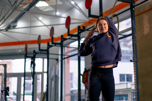 Wallpaper Mural in the gym coach girl in a warm sweatpants standing doing a warm-up before training Torontodigital.ca