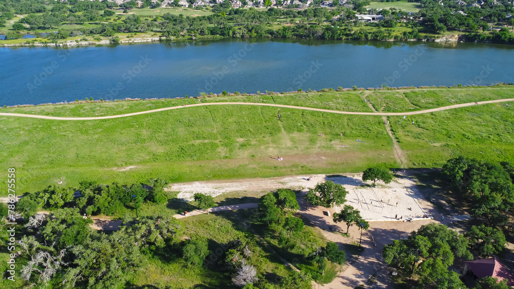 Aerial view sand volleyball courts with people playing near nature trails of Brushy Creek Lake Park next master-planned community in Brookside neighborhood near Austin, Cedar Park, Round Rock