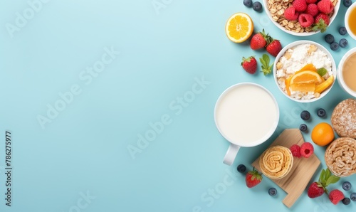 Top view of Healthy breakfast concept with fresh pancakes, berries, fruit on blue backgroudt. Free space for your text.